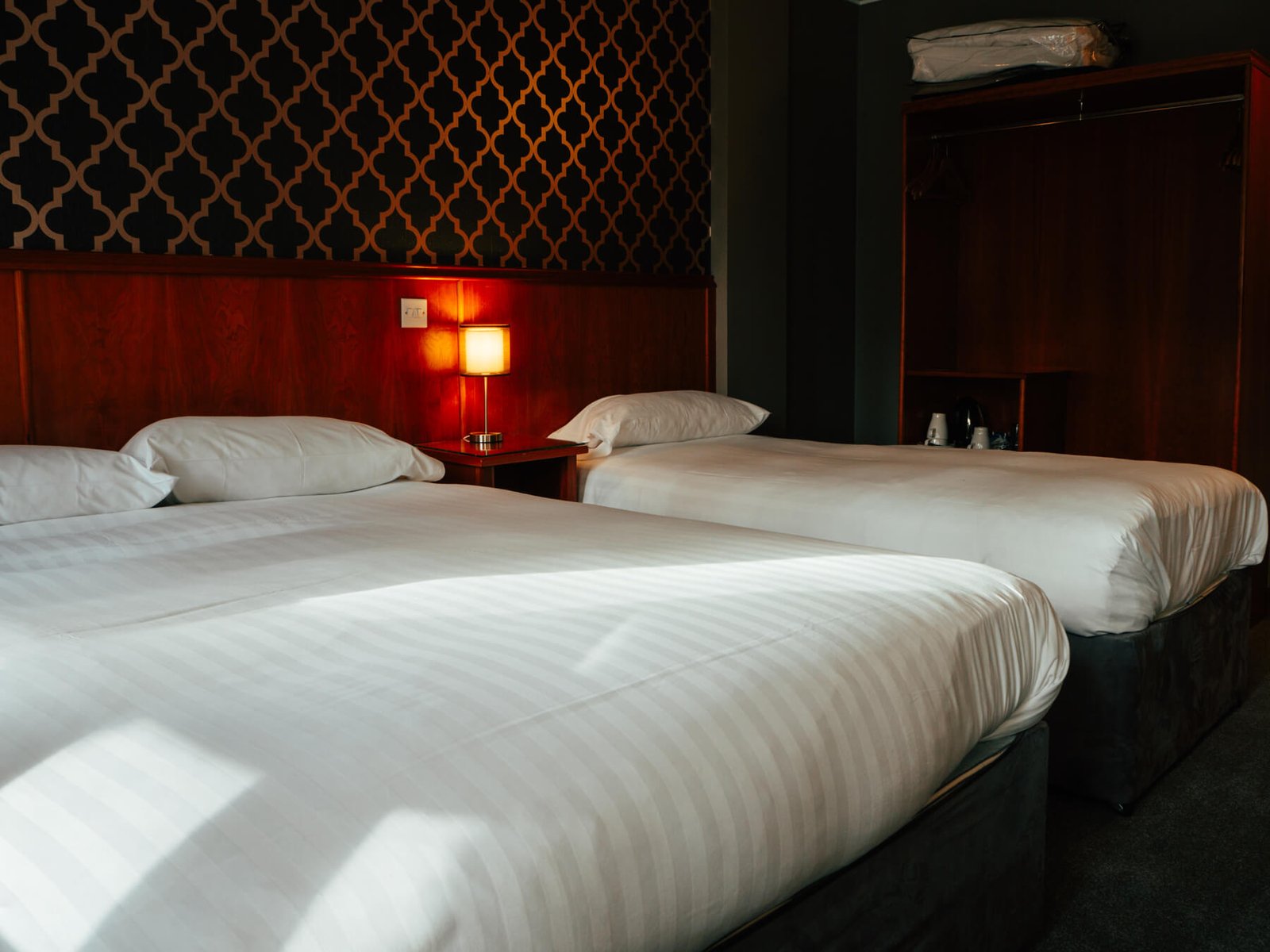 cozy hotel room with two beds and warm lighting du 2024 08 19 23 36 15 utc.jpg